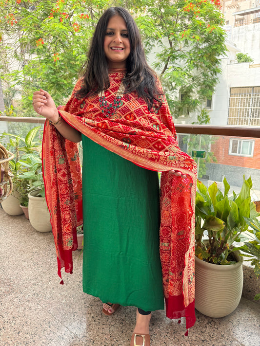 Red shade handwoven bareek bandhani meena kari jaal in premium georgette kurta set with bottle green gajji dupatta