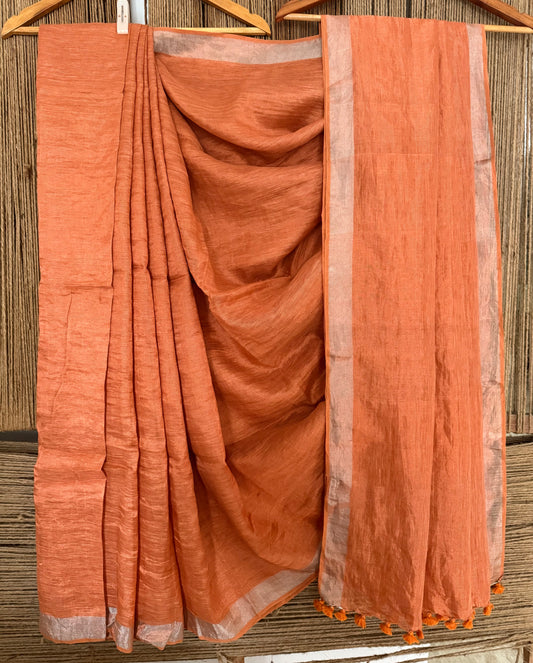 Coral orange silver metallic linen sari with woven  border and tassels